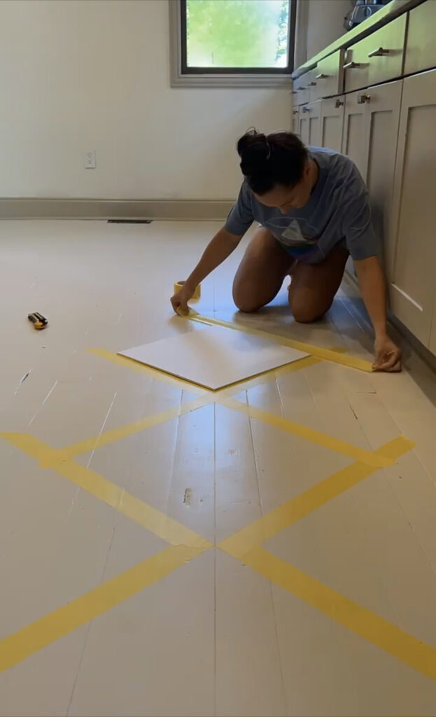 Katie taping out the pattern of the painted harlequin floor.