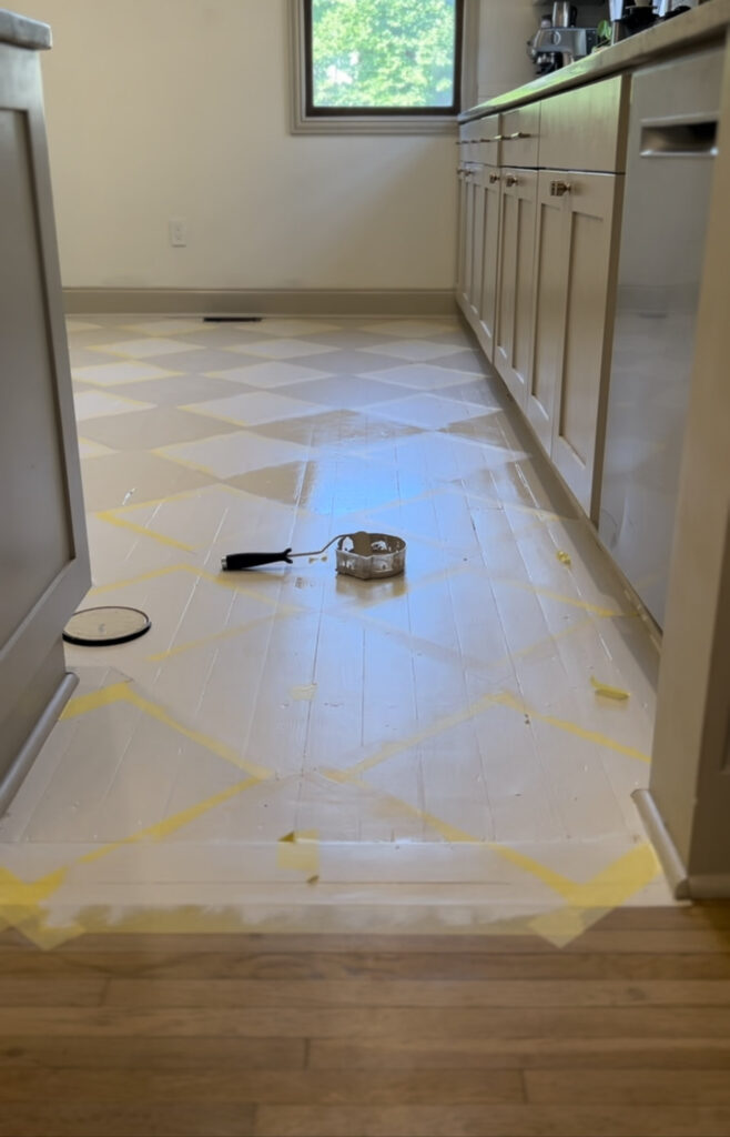 Painting alternating squares to create the painted harlequin floor.