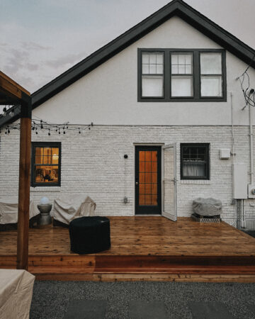 Backdoor Refresh - image of rainy patio with freshly madeover back door painted in a dark charcoal.