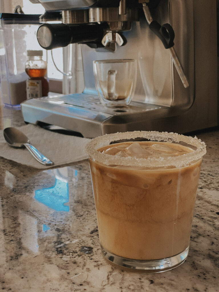 A glass of coffee on the counter for Katie's "Gifts for Coffee Lovers" post.